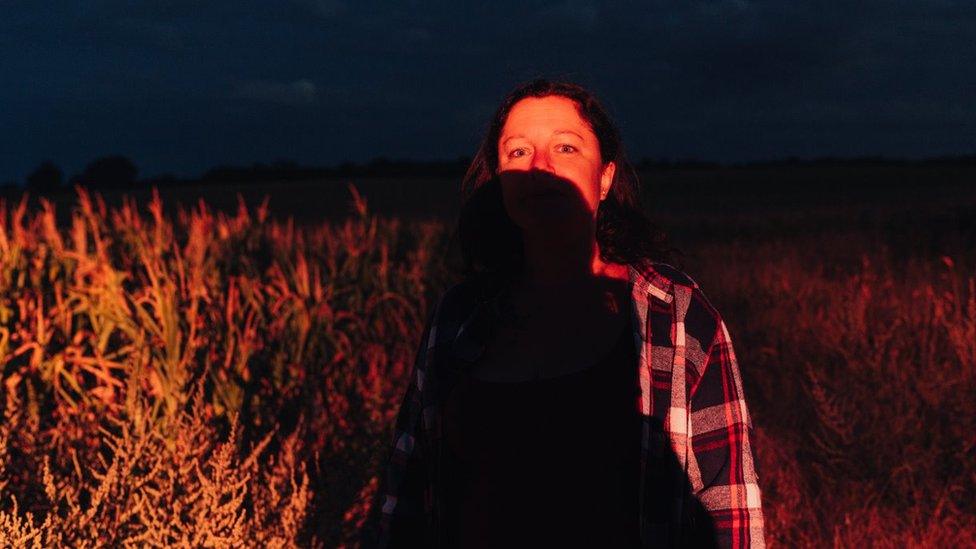 Woman with a dark shadow across her face