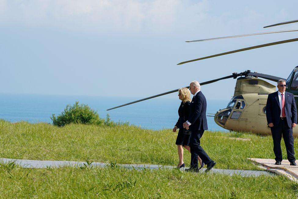 U.S. President Joe Biden and U.S. First Lady Jill Biden walk as they disembark from Marine One at Normandy American Cemetery and Memorial in Colleville-sur-Mer, France, June 6, 2024.