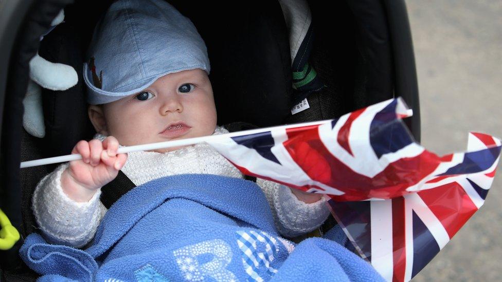 Four month old Harry Pettie waves his Union Jack as he waits for Queen Elizabeth II and Prince Philip, Duke of Edinburgh to arrive at Tweedbank Station