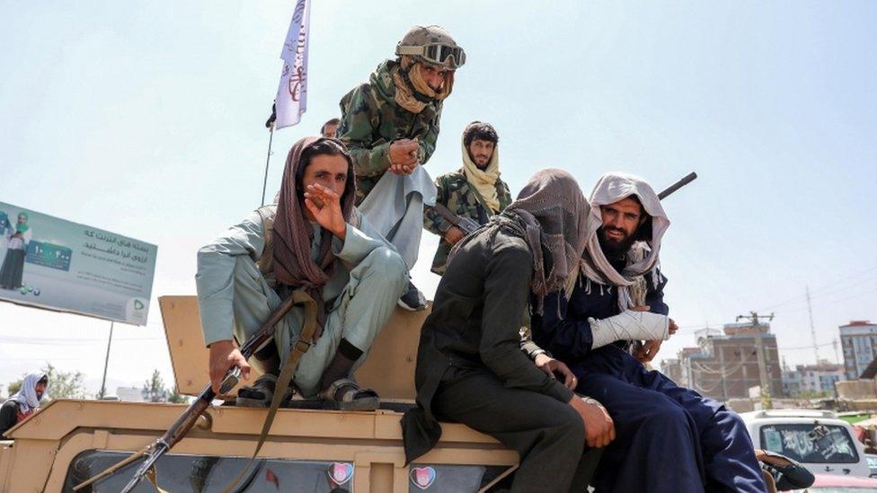 Taliban fighters are seen on the back of a vehicle in Kabul, Afghanistan, 16 August 2021.