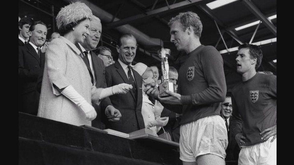 England win the World Cup in 1966, as Bobby Moore receives the trophy from Queen Elizabeth II.