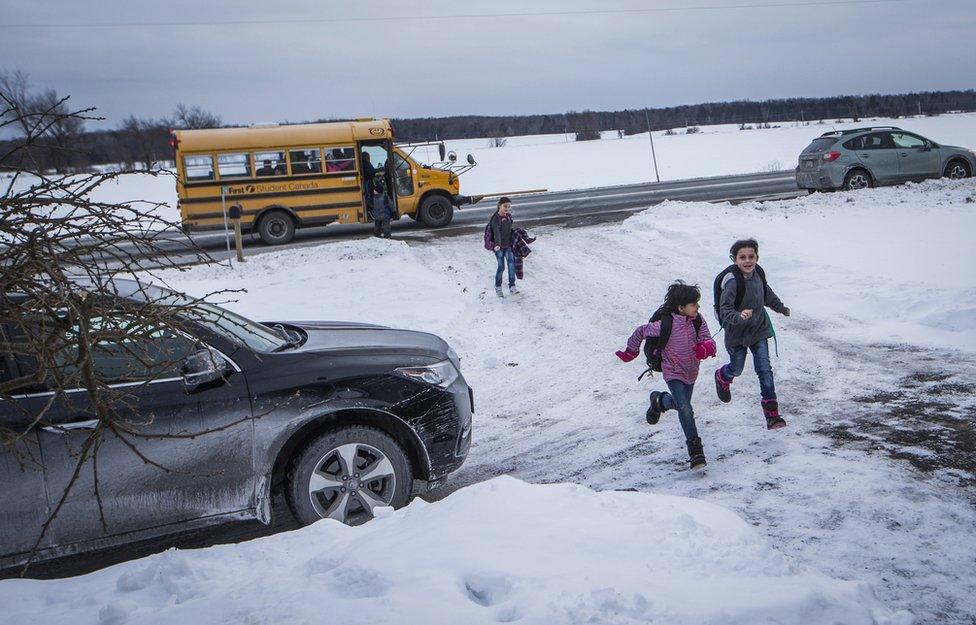 Syrian refugee kids from the Al Jasem family return home after being dropped off in a school bus to their temporary home in Picton, Ontario, Canada, Wednesday January 20, 2016