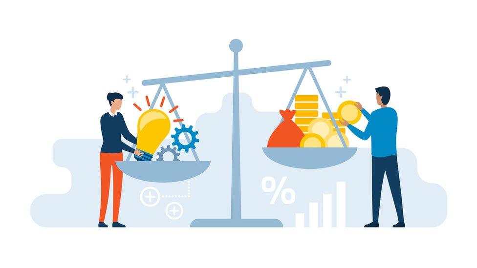 people weighing up energy and production and money on some large scales