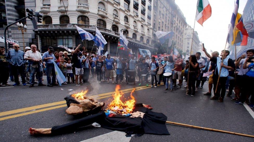 An effigy of President Obama was burnt during the marches in Buenos Aires