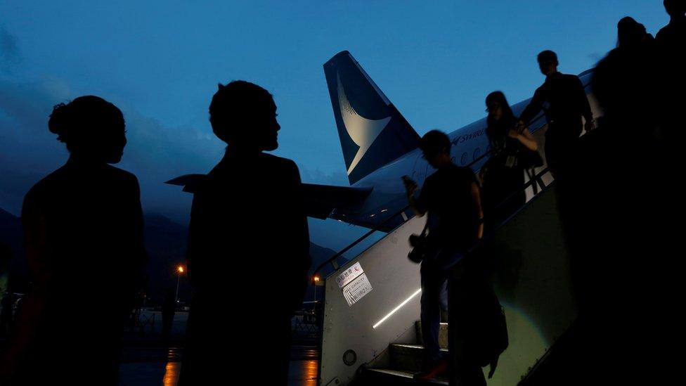 Guests descend from a Cathay Pacific Airways Airbus A350 after a tour of the aircraft cabin at Hong Kong Airport May 30, 2016.