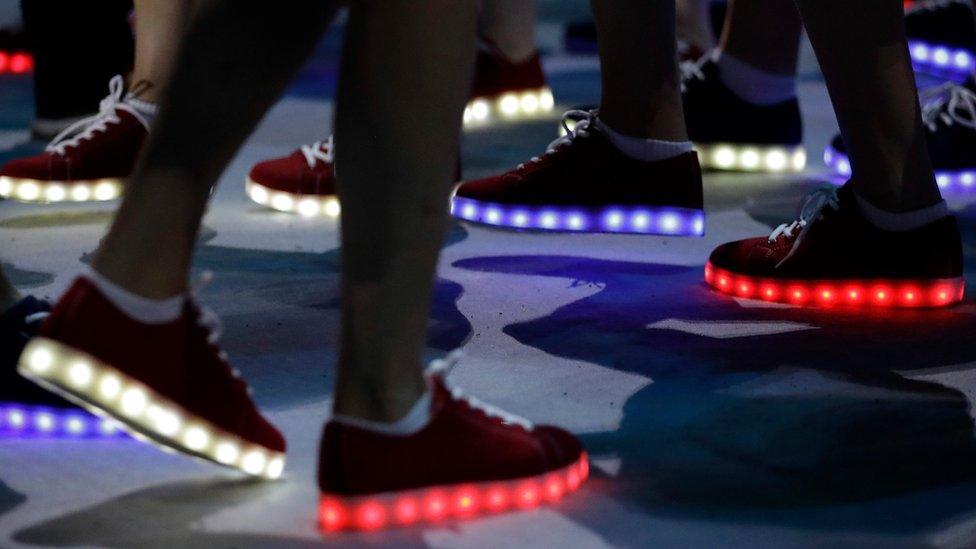 British athletes wear glooming shoes during the closing ceremony in the Maracana stadium at the 2016 Summer Olympics in Rio de Janeiro, Brazil, Sunday, Aug. 21, 2016