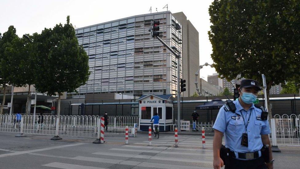 A policeman patrols outside the US embassy in Beijing