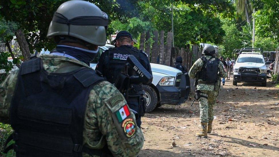 Mexican police and security forces inspect the area where police officers were killed in Coyuca de Benítez, Guerrero state. Photo: 23 October 2023