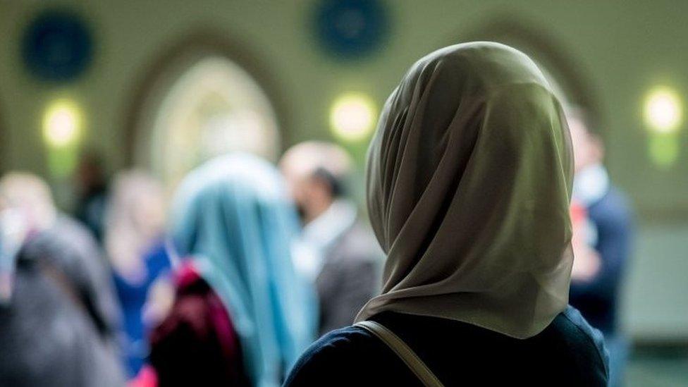 Muslim women stand in the Aya Sofya mosque on October 3rd, 2016 in Hanover, northern Germany, as visitors attend the Open-Mosque-Day