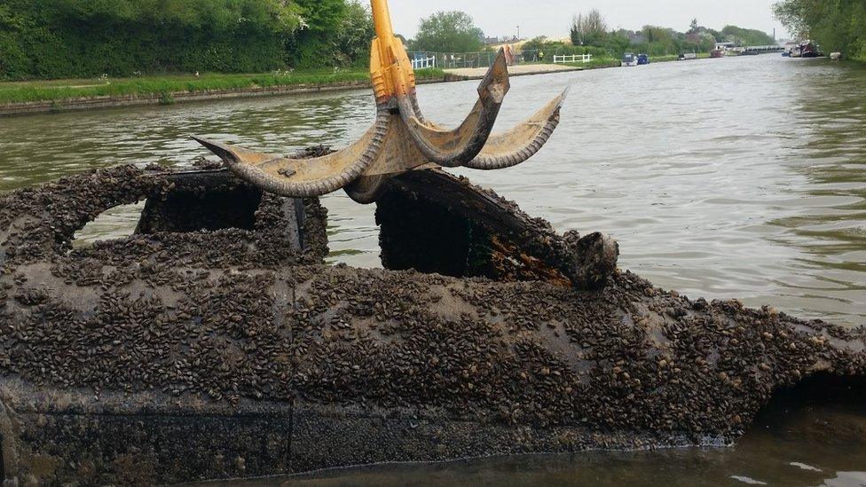 Car being pulled from canal