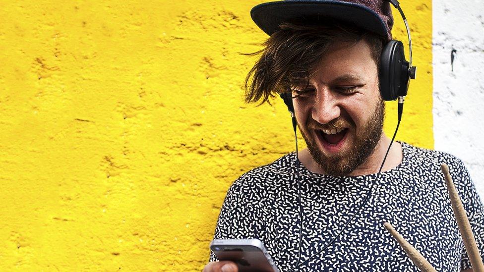 Man wearing headphones listening to music