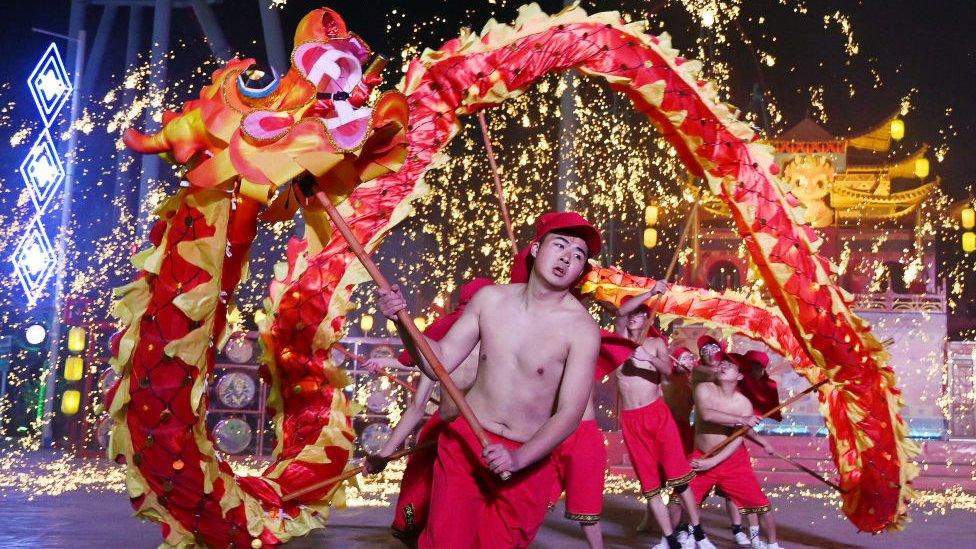 Dragon dancers perform in a park in Beijing