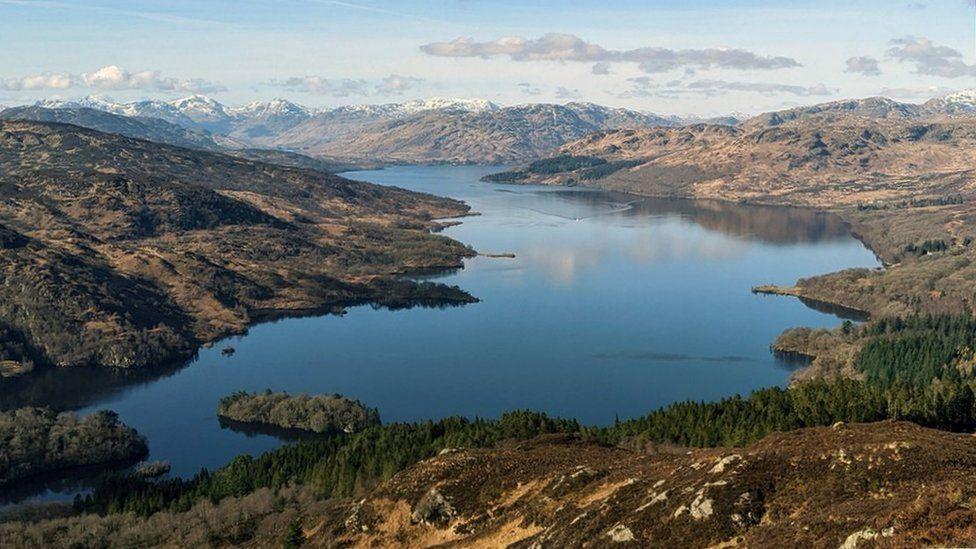 Loch Katrine viewed from the top of Ben A'an, looking west to the snow-topped Arrocher Alps