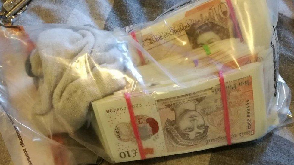 One of four bags of cash found in the property