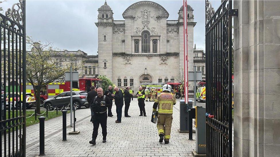 Crews in attendance outside the university's main building