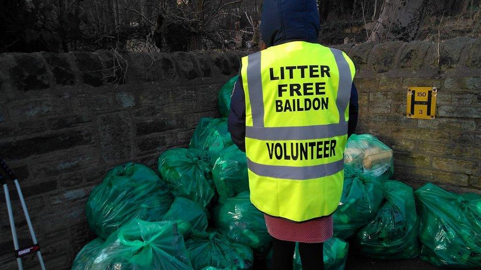 A person cleaning up litter