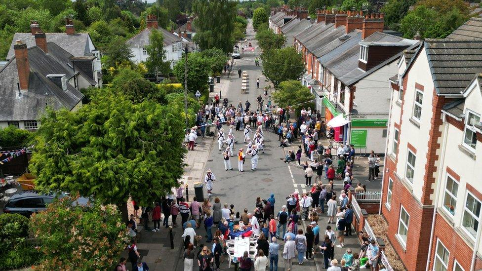 Residents watch Morris dancers during the Knighton Church Road street party on 3 June 2022 in Leicester