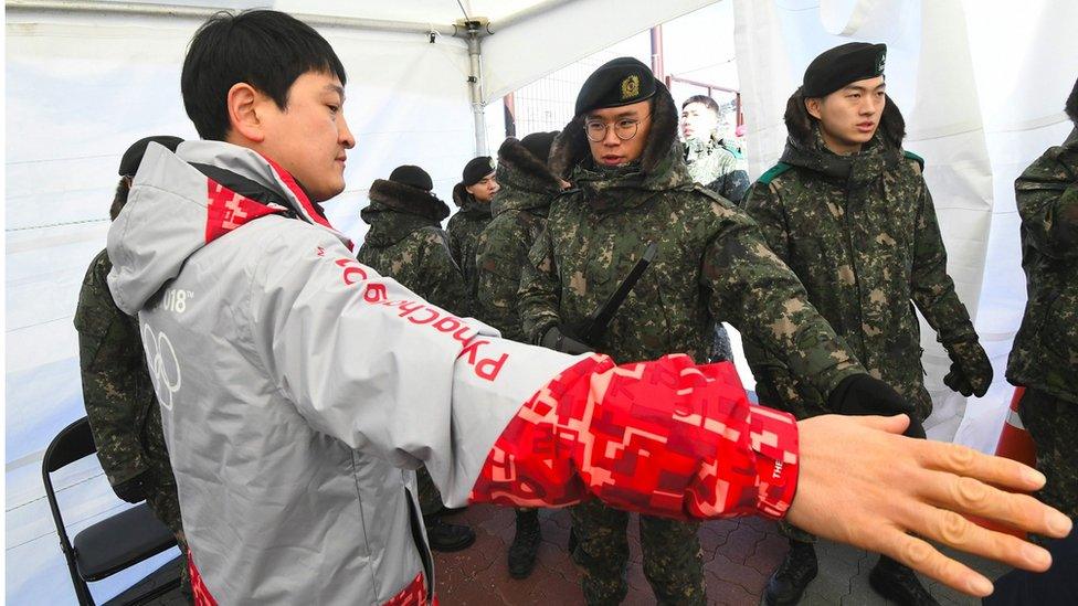 man being frisked by soldier