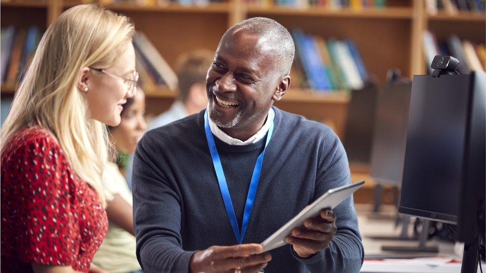 A teacher talking to a student