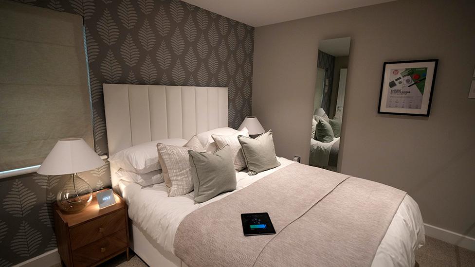 An infrared wall panel that doubles as a mirror and heated skirting boards are seen in one of the research and testing homes built inside the Energy House 2 research facility at Salford University