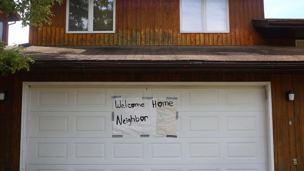 A welcome home sign left on a garage door in the Thickwood neighbourhood of Fort McMurray, Alberta on June 3, 2016