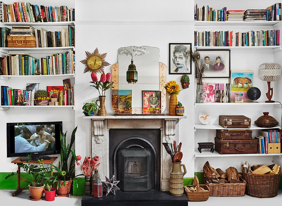 A photo by Zineb Sedira showing a living room with lots of personal possessions