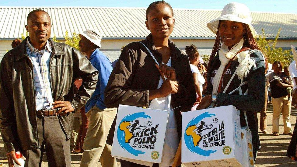 Two of some 6,400 Namibian volunteers, Pauline Amoomo (L) and Helen Shishibeni (R) carry the vaccine boxes, 21 June 2006, in the street of the Namibian Capitol Windhoek.