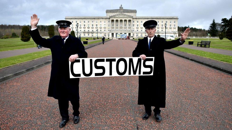 Two men dressed as customs officers take part in a protest outside Stormont against Brexit and it"s possible effect on the north and south Irish border on March 29, 2017 in Belfast, Northern Ireland