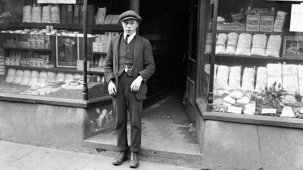 Black and white photo of Harold Jones outside a shop