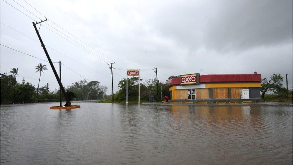 A road next to a convenience store is flooded after Hurricane Grace slammed into the coast with torrential rains, in Costa Esmeralda, near Tecolutla, Mexico, 21 August 2021