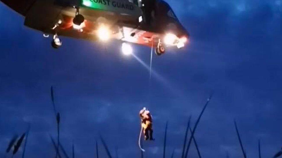 Woman being winched to safety