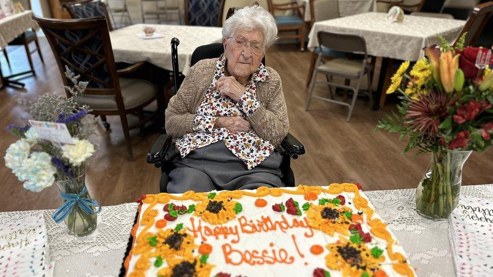 Woman smiles before a cake