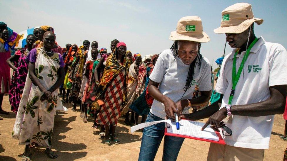 Two members of the German NGO Welthungerhilfe (WHH) register the beneficiaries of a food distribution on March 4, 2017, in a stabilisation center in Ganyiel, Panyijiar county, in South Sudan