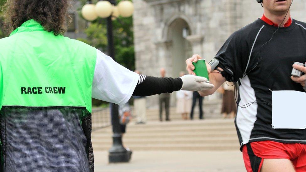 A marathon runner drinking