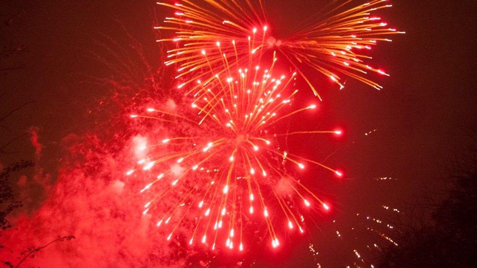 A red firework explodes in Ravenscourt Park in 2009