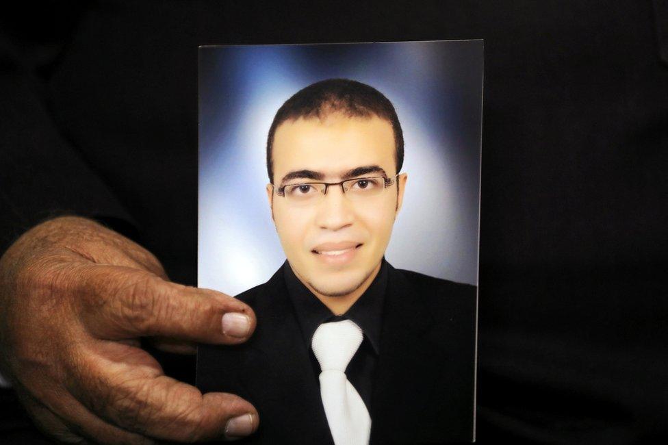 Reda al-Hamamy, the father of Abdullah al-Hamamy who is suspected of attacking a soldier in Paris's Louvre museum, holds a picture of his son during an interview with Reuters in Daqahliya, Egypt, 4 February