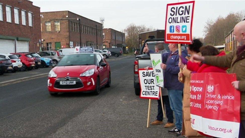 Campaigners and a car