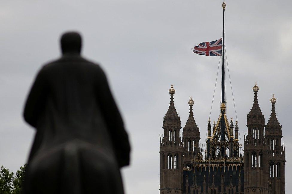 Flag flying at half mast above the Houses of Parliament.