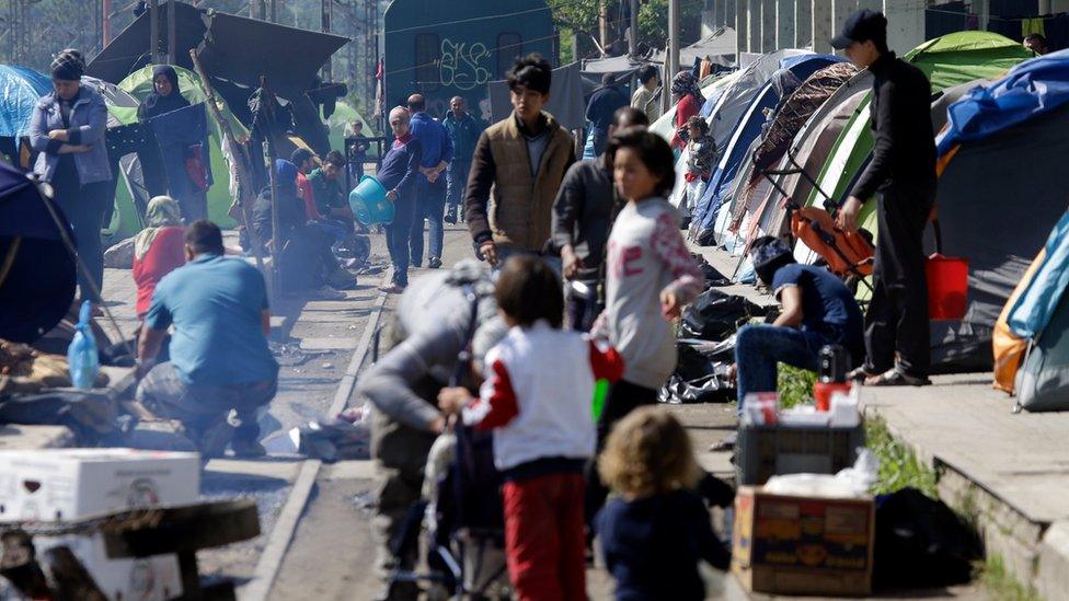 Migrants and refugees crowd the tracks of a railway station used as a makeshift camp at the northern Greek border point of Idomeni, Greece on 5 May