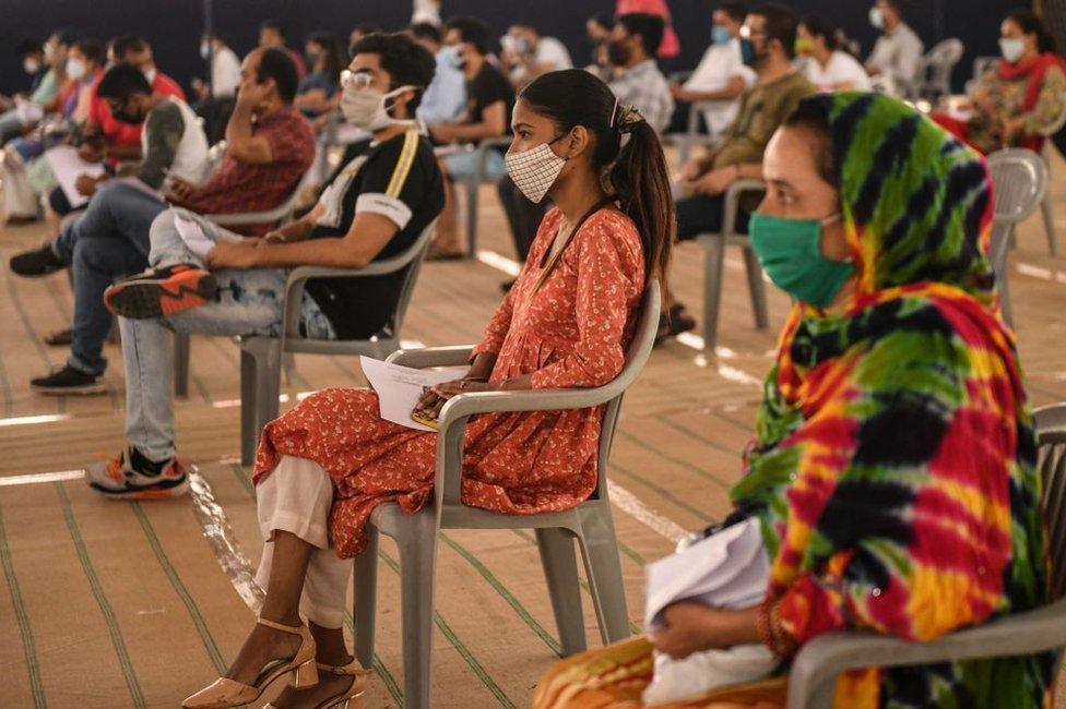 People wait to get inoculated with a dose of the Covishield Covid-19 coronavirus vaccine at Radha Soami Satsang Beas Centre in Amritsar on May 19, 2021.