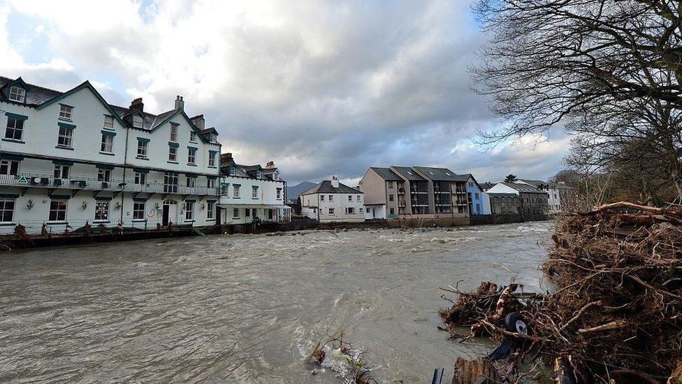 A swollen River Greta and debris at the bank sides
