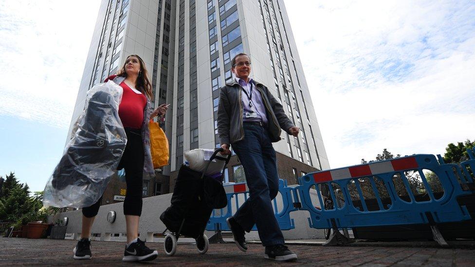 Residents leave the Chalcots Estate in Camden, after being evacuated