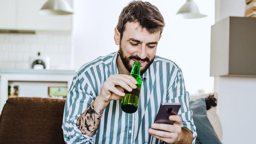 A man drinking at home