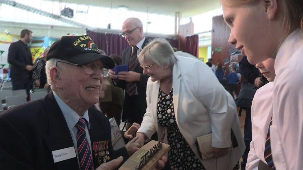 Teddy Dixon presented pupils with a plaque made of sand from Utah Beach