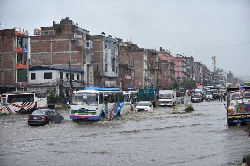 Vehicles travelling through water logged road at Banepa, Kavrepalanchok, Nepal on Friday, July 12, 2019.