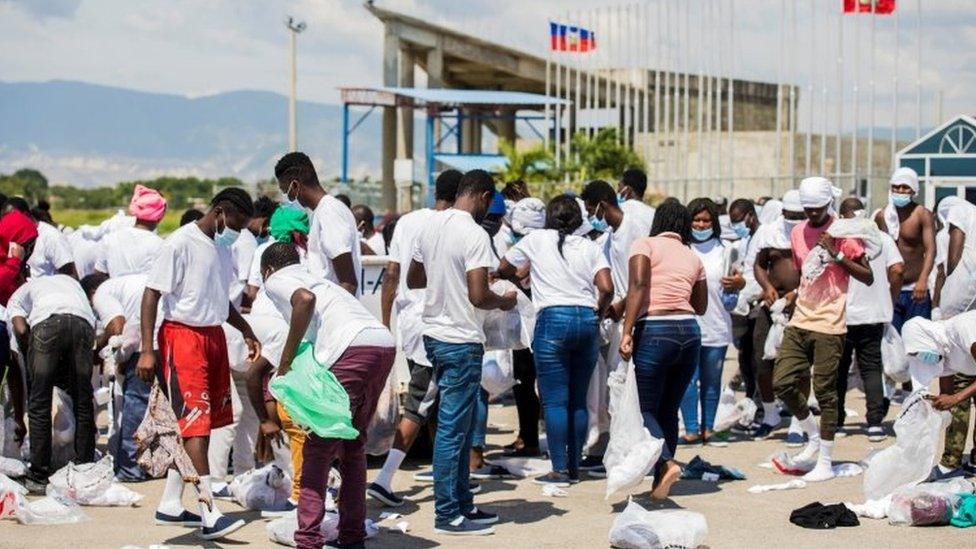 People look for their belongings after they were left on the tarmac