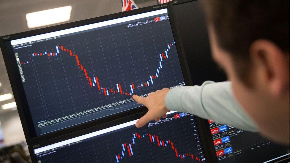 A trader works in central London on Wednesday after the US election result