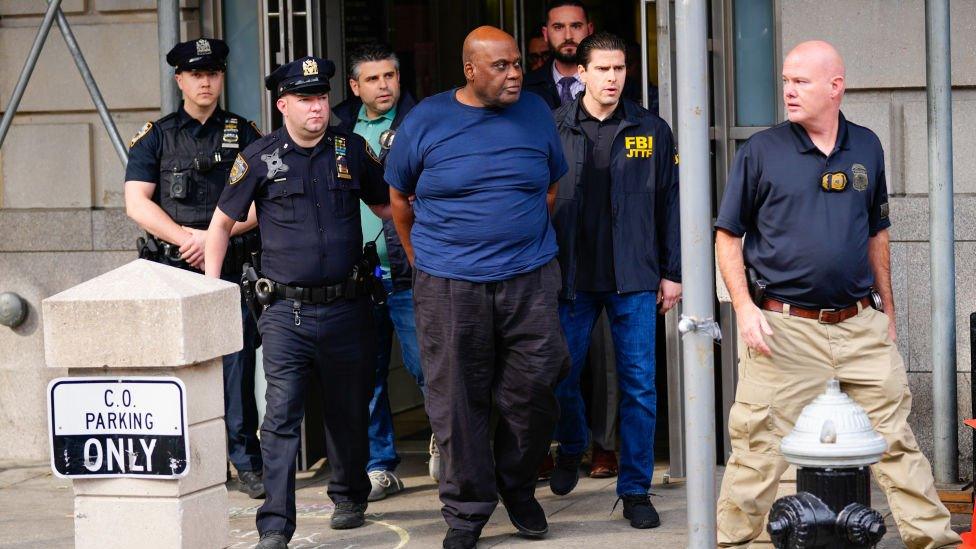 Suspect Frank James is seen at the Ninth Precinct after being arrested