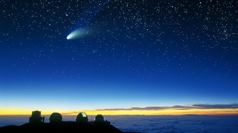 Telescope domes and a comet are seen on Mauna Lea