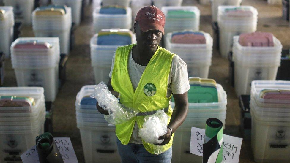 A Kenyan man wearing a high-visibility vest